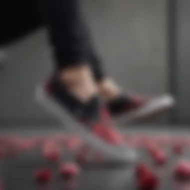 Athlete wearing black slip-on Vans with rose design mid-air