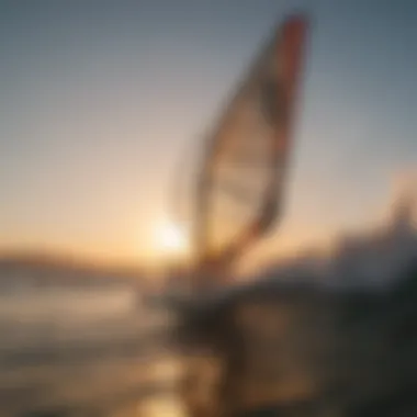 Windsurfer catching air off a wave with the sun setting in the background