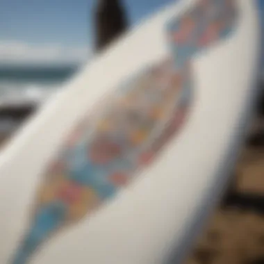 A close-up of a surfboard adorned with stickers reflecting the surf culture.