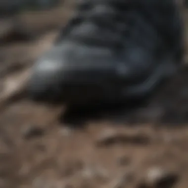 Close-up of black Adidas shoe tread pattern on rugged terrain