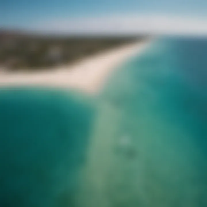 Dramatic aerial view of kite boarders gliding over crystal-clear azure waters