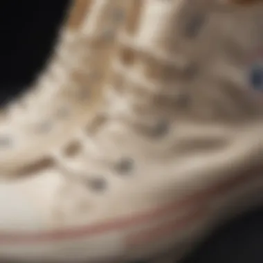 Close-up of cream Converse shoes with intricate stitching details