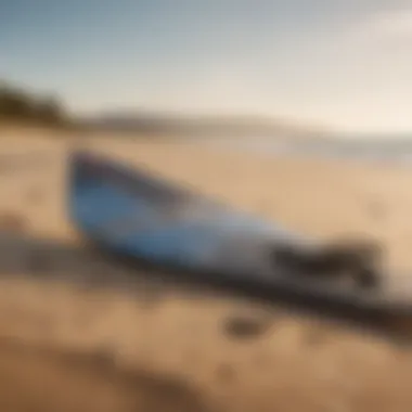 Kiteboarding equipment laid out on the sandy beach