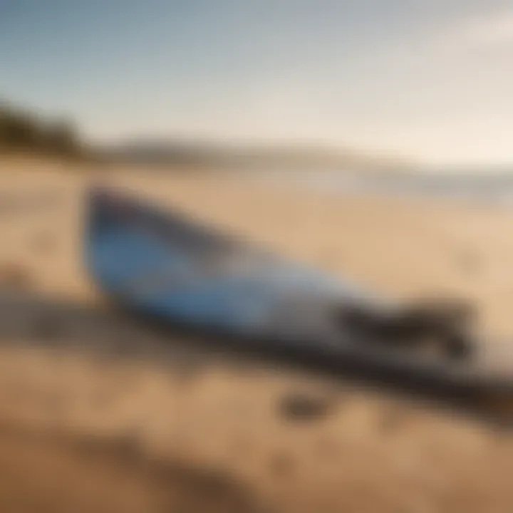 Kiteboarding equipment laid out on the sandy beach