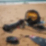 Collection of kitesurfing gear laid out on the beach