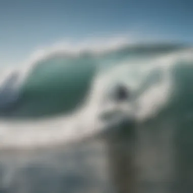 Surfer riding a wave at Blacks Beach