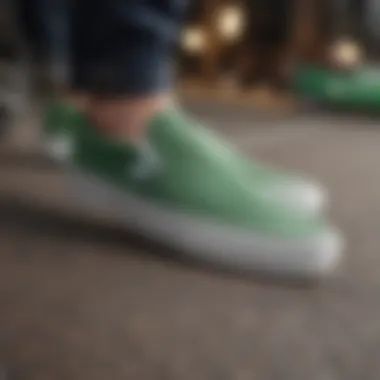 A stylish individual wearing green and white slip-on Vans at an extreme sports event.