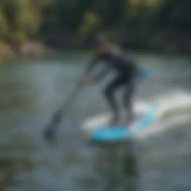 An aerial shot of a rider gliding above water on a foil SUP board.