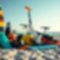 A collection of various kitesurf equipment arranged on a beach.