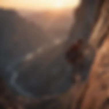 Silhouetted rock climber scaling a steep cliff at sunset