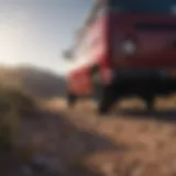 Maroon and black vans racing through rugged terrain