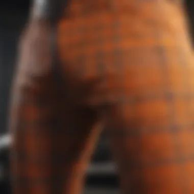 Close-up of durable fabric and stitching of orange plaid pants