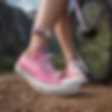 Close-up of pink low platform Converse on a mountain biking trail