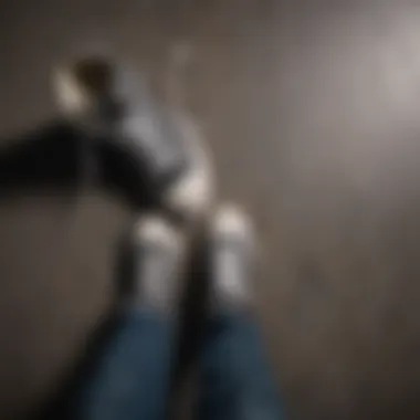 Artistic top view shot of dark grey Converse high tops with shadow play