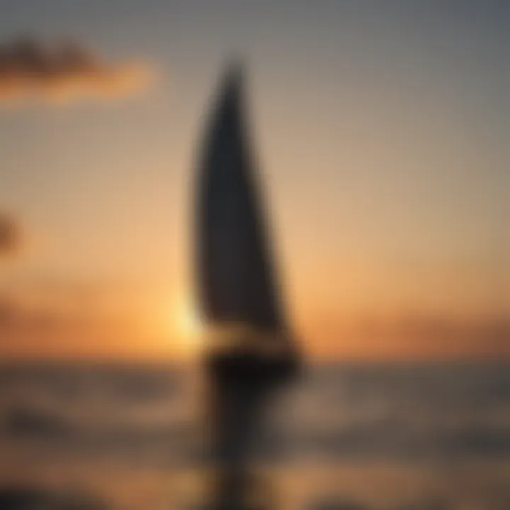 Dramatic sunset over the horizon with a sailboat in silhouette