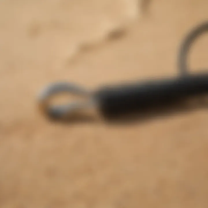 Surfboard leash coiled on sand