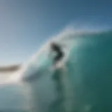 Surfer catching a wave under the clear blue sky