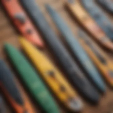 A selection of different types of kiteboard fins arranged on a wooden surface.