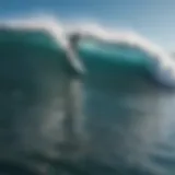 Aerial view of surfers riding waves under a clear blue sky