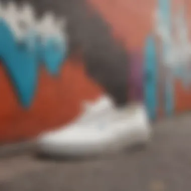 Close-up of Vans Authentic Off White sneakers against a vibrant graffiti wall