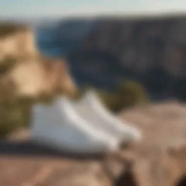 White suede Vans standing at the edge of a cliff overlooking a breathtaking view